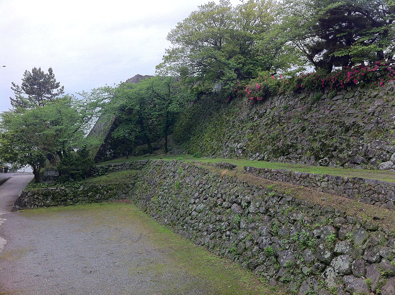 日出城址の天守台の石垣と城下公園の道。2012年5月の写真。